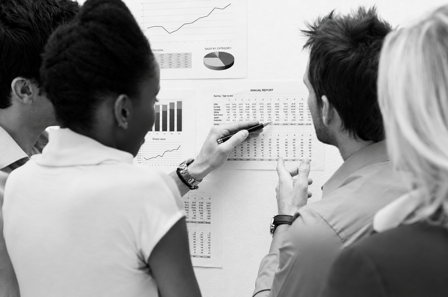 A startup team reviewing a comparison chart of software development agencies