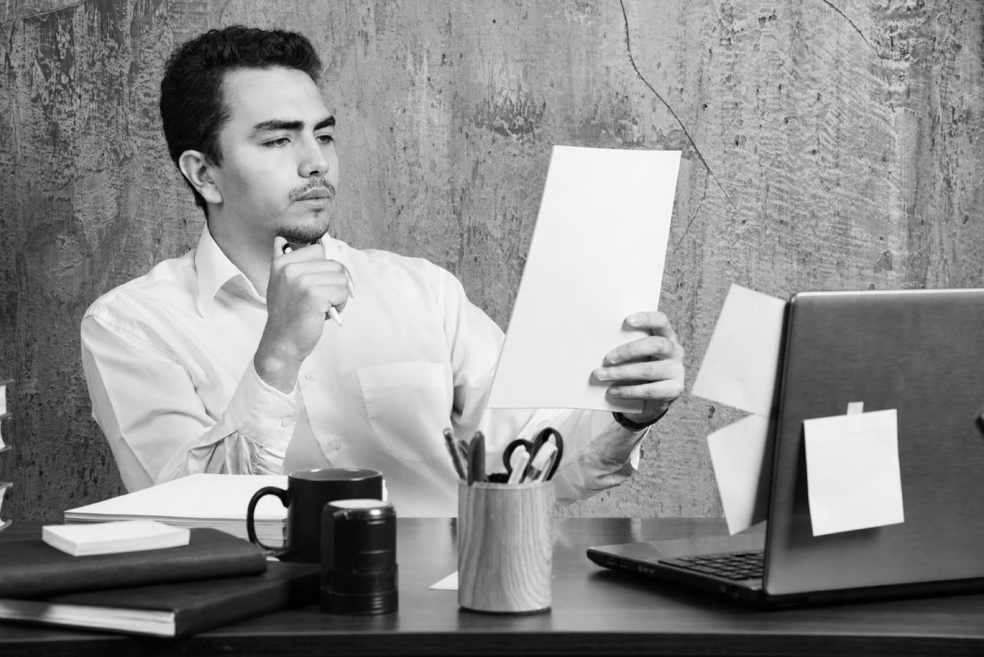 A founder reviewing a list of repeated customer feature requests on a laptop
