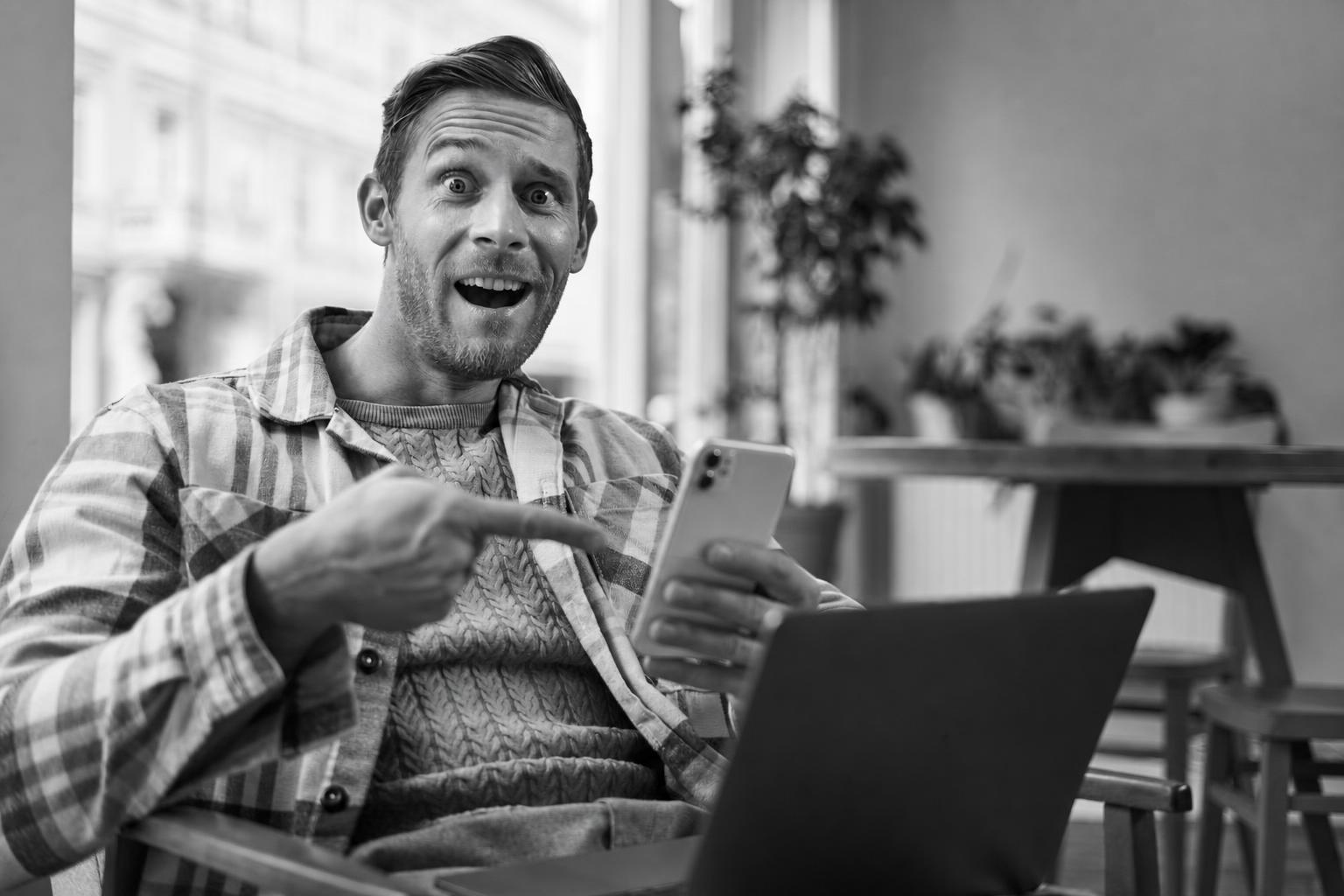 A person unprompted, pointing at and recommending an app on their phone
