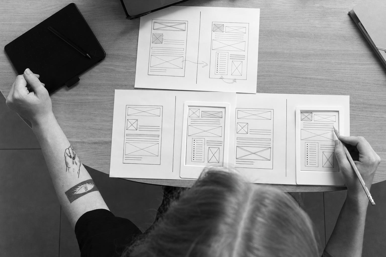 A designer's rough wireframe sketches for an early product prototype