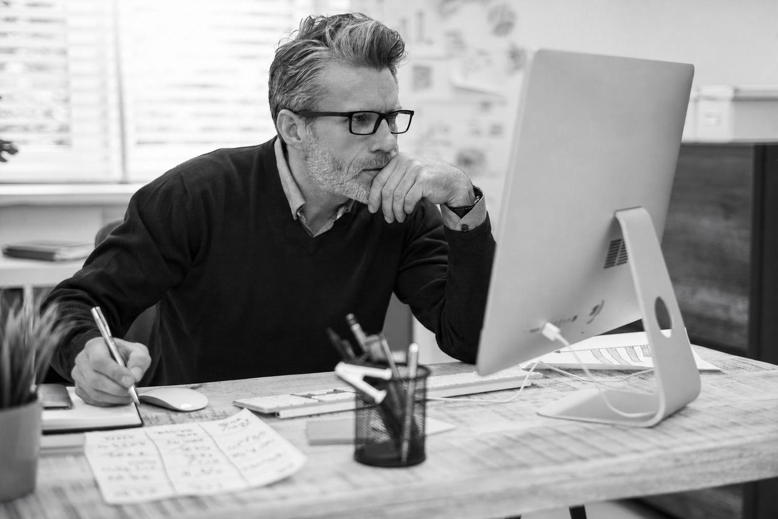 A non-technical founder at a desk working through a product decision