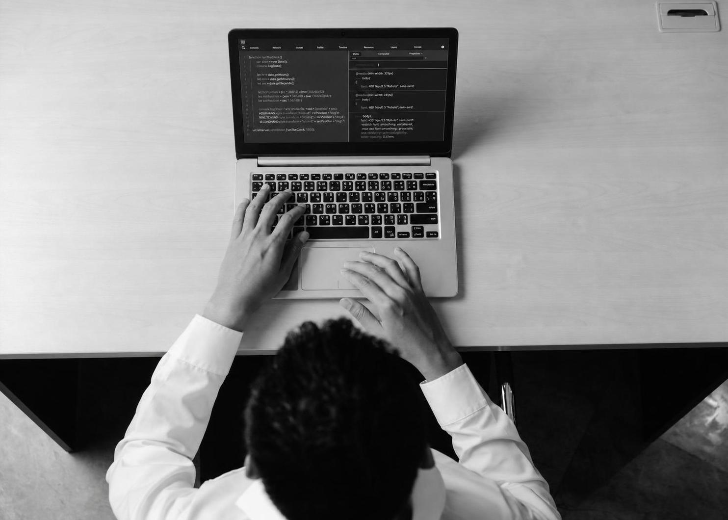 A developer running a technical experiment at a laptop to validate a product idea