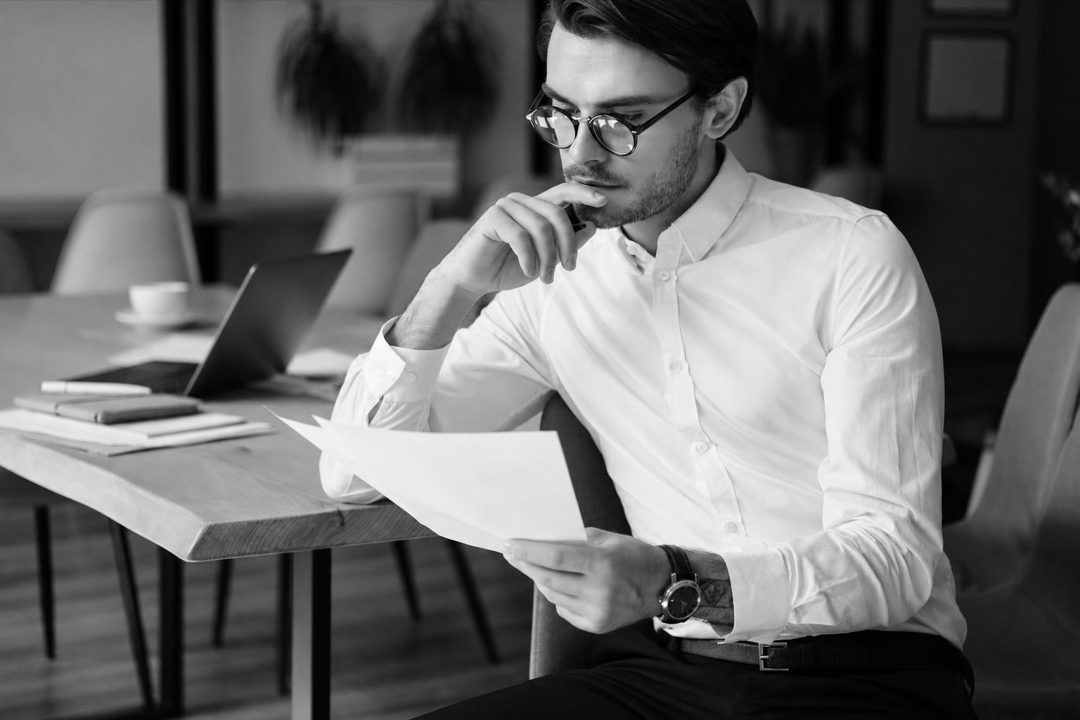 Founder thoughtfully reading through notes before deciding